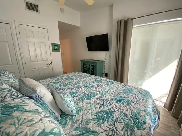 a bedroom with a bed and a flat screen tv