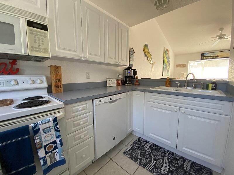 343 Ocean Park Lane, Unit V110 Cape Canaveral, FL 32920 - Photo 20 of 25 a kitchen with appliances a sink and cabinets