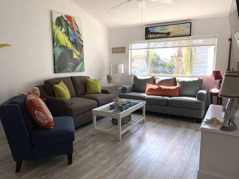 343 Ocean Park Lane, Unit V110 Cape Canaveral, FL 32920 - Photo 2 of 25 a living room with furniture and a large window