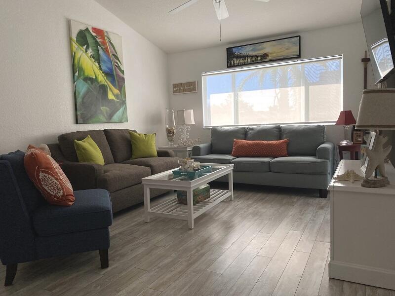 343 Ocean Park Lane, Unit V110 Cape Canaveral, FL 32920 - Photo 23 of 25 a living room with furniture and a window