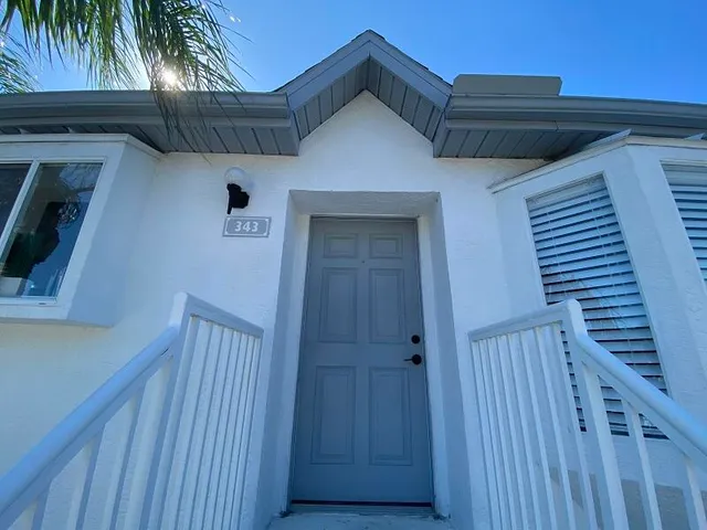 a view of a house with wooden deck