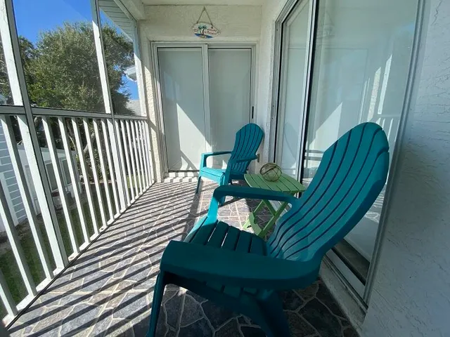 a view of a balcony with chairs