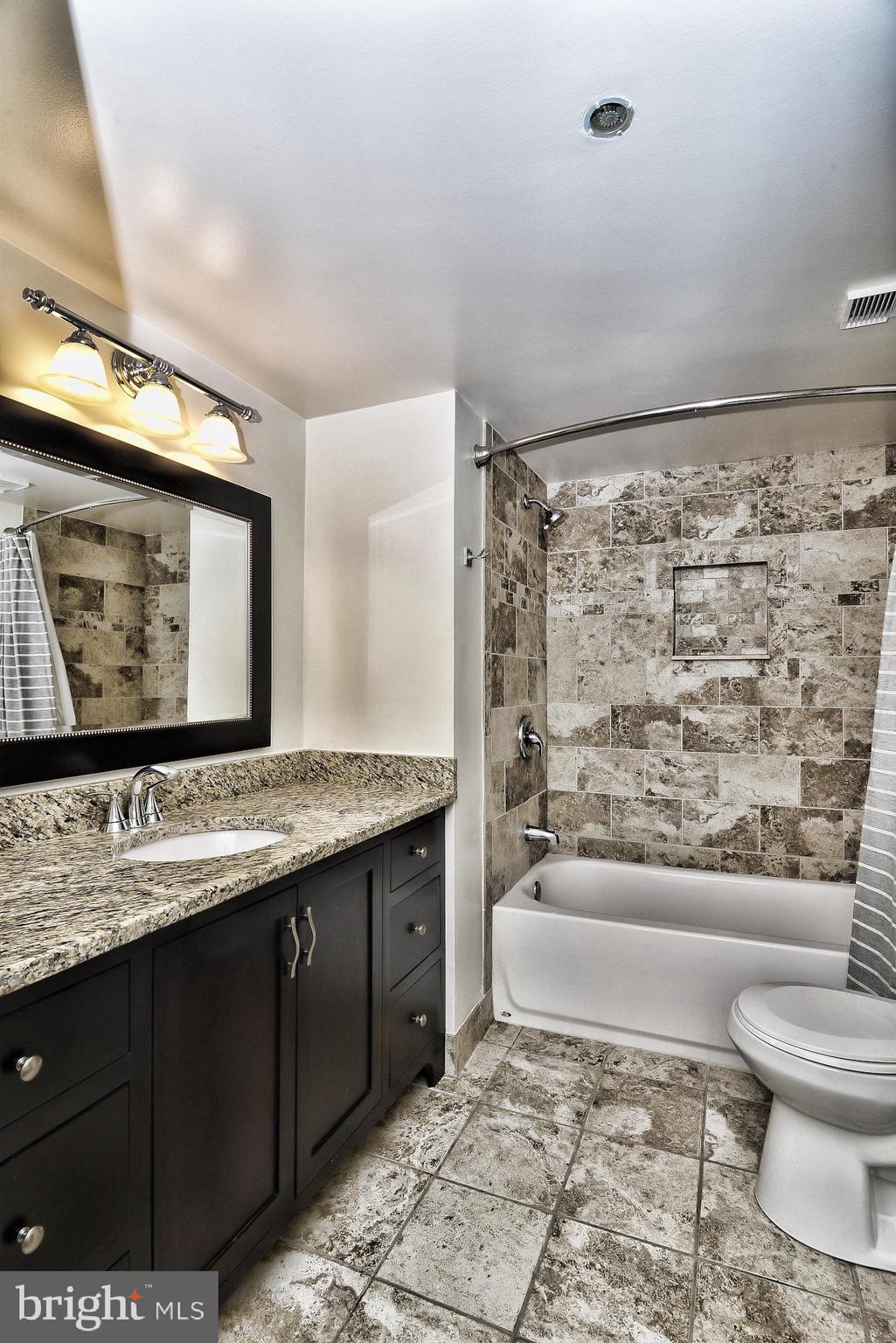 5505 Seminary Road, Unit 1817N Falls Church, VA 22041 - Photo 14 of 31 a bathroom with a granite countertop sink toilet and shower