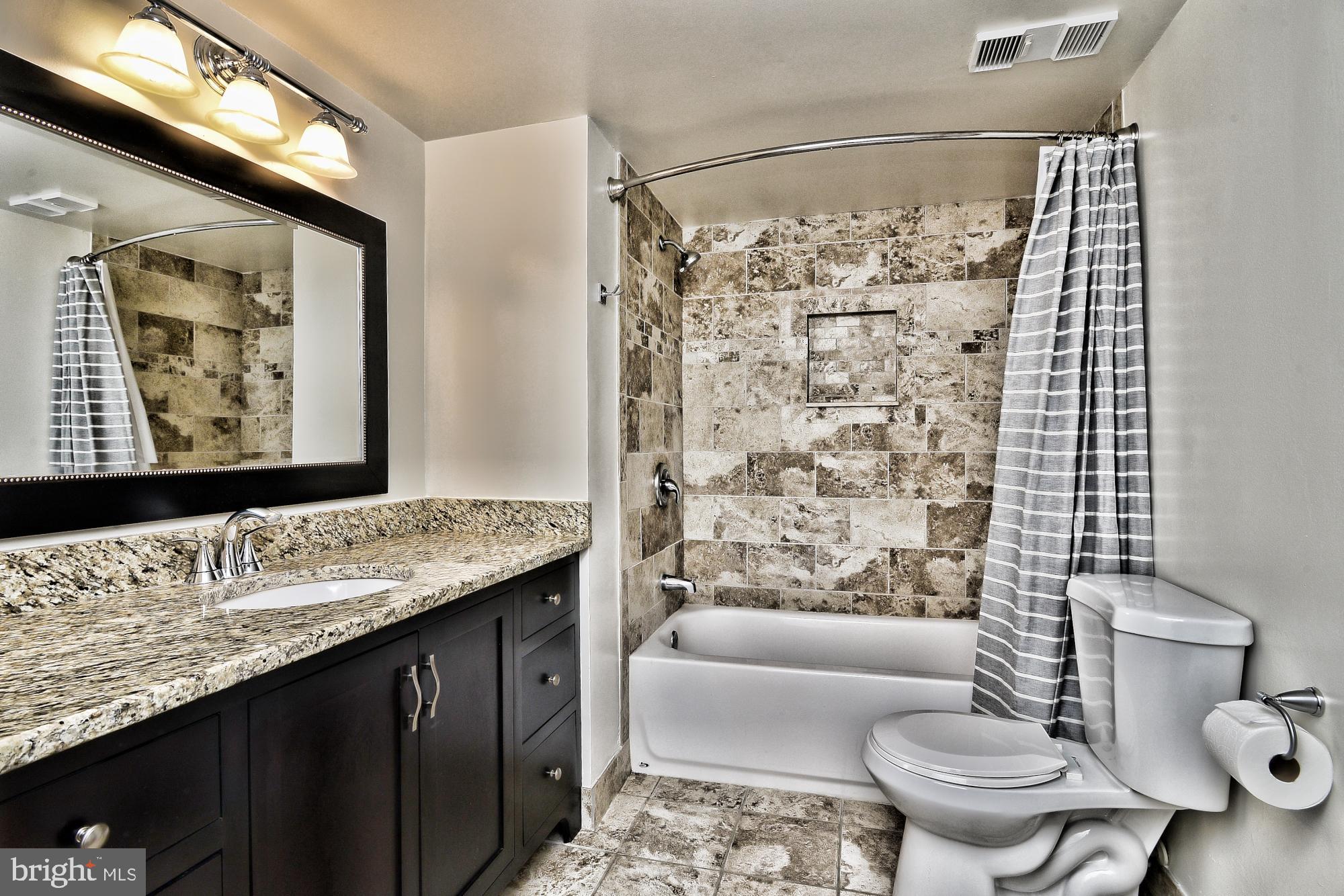 5505 Seminary Road, Unit 1817N Falls Church, VA 22041 - Photo 15 of 31 a bathroom with a granite countertop sink and a mirror