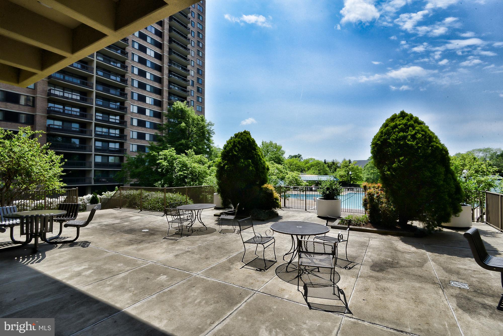 5505 Seminary Road, Unit 1817N Falls Church, VA 22041 - Photo 27 of 31 a view of a patio with a table and chairs under an umbrella