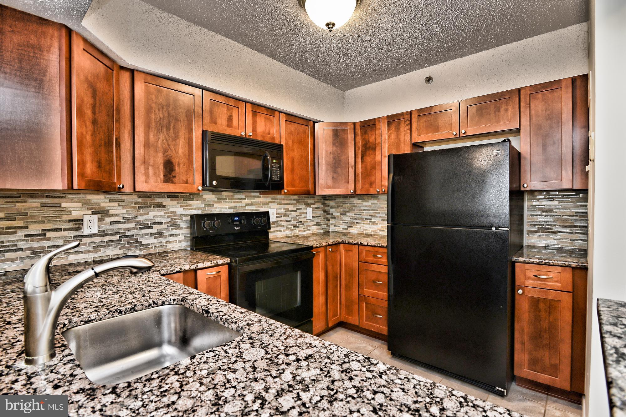 5505 Seminary Road, Unit 1817N Falls Church, VA 22041 - Photo 5 of 31 a kitchen with stainless steel appliances granite countertop a refrigerator stove and sink