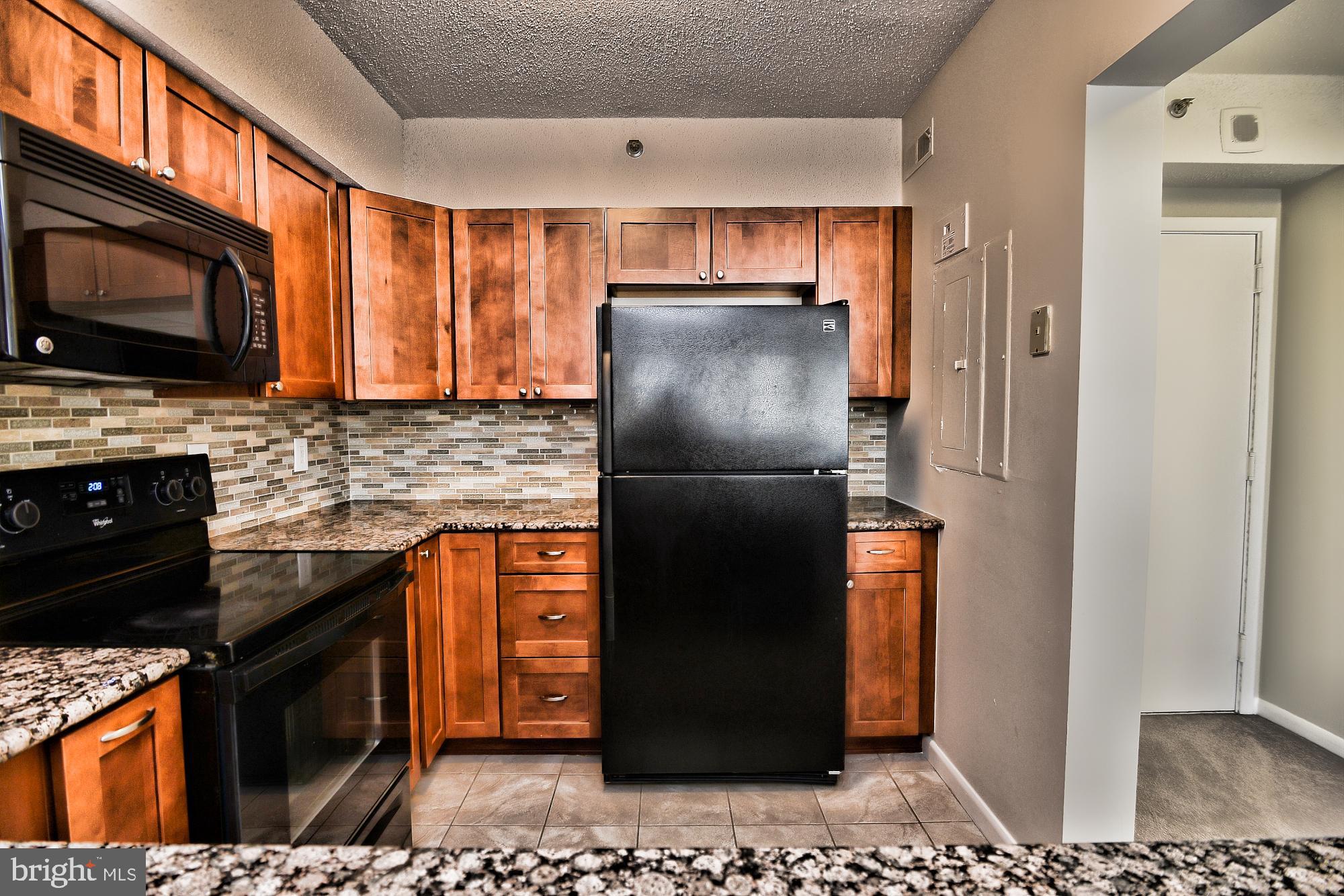 5505 Seminary Road, Unit 1817N Falls Church, VA 22041 - Photo 7 of 31 a kitchen with stainless steel appliances granite countertop a refrigerator a stove a sink and a microwave