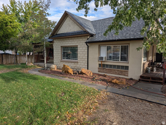 1341 East Crk Road Sandy, UT 84093 - Photo 4 of 24 View of front of home with a shingled roof, a deck, and concrete block siding