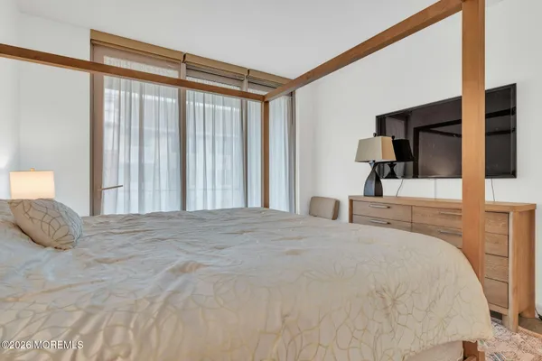 a bedroom with a large bed and a large window