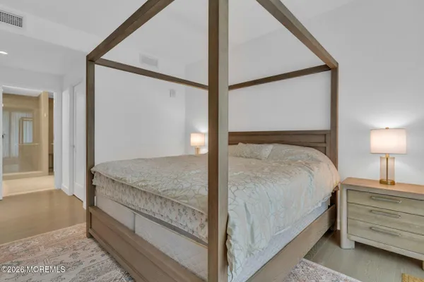 a bedroom with a bed and a mirror