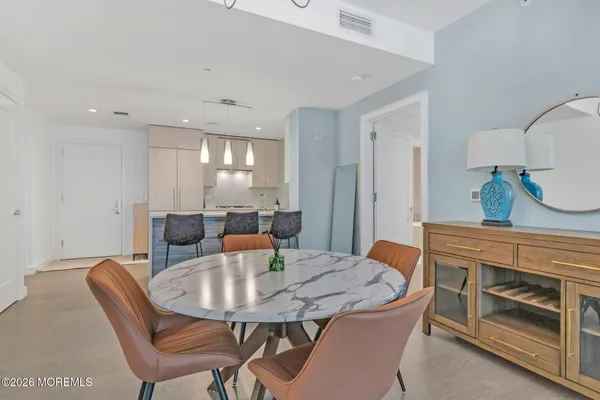a view of a a dining room with furniture and wooden floor