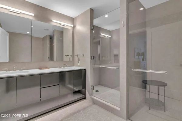 a bathroom with a shower sink and mirror