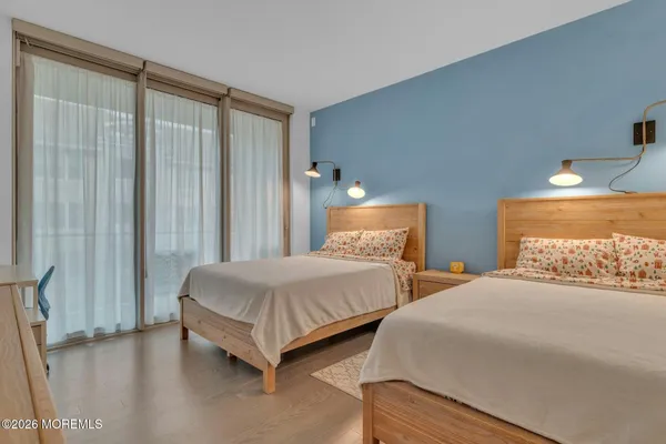 a bedroom with two beds and a window