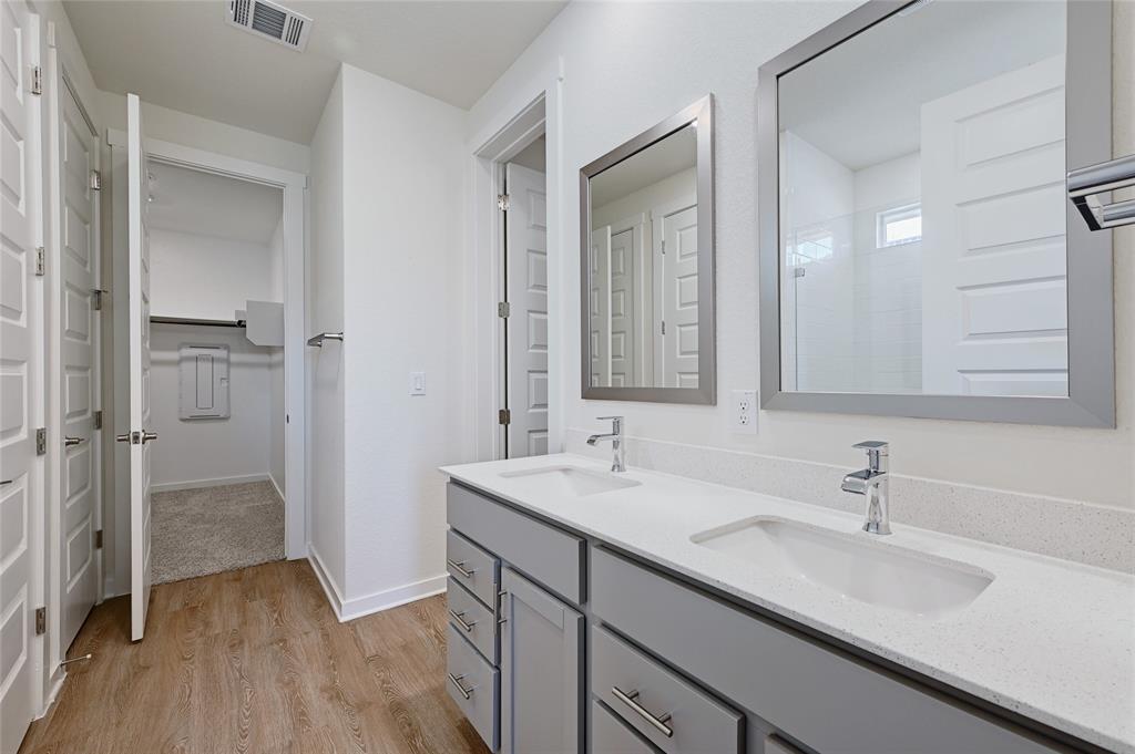 2133 Alamar Walk Leander, TX 78641 - Photo 13 of 25 a bathroom with a sink and a mirror