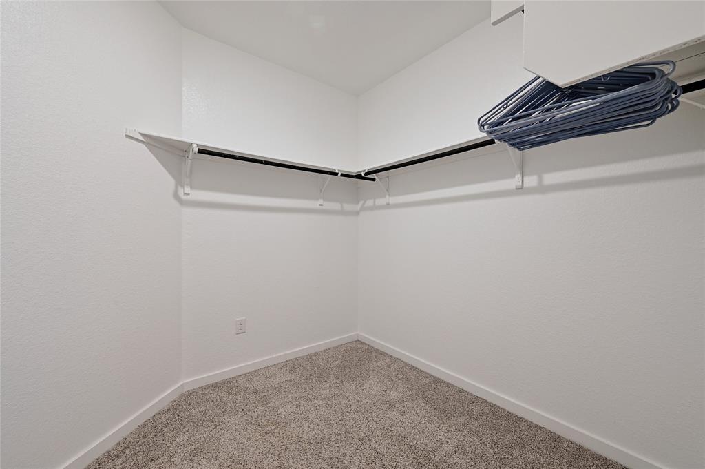 2133 Alamar Walk Leander, TX 78641 - Photo 14 of 25 a view of a room with racks on the wall