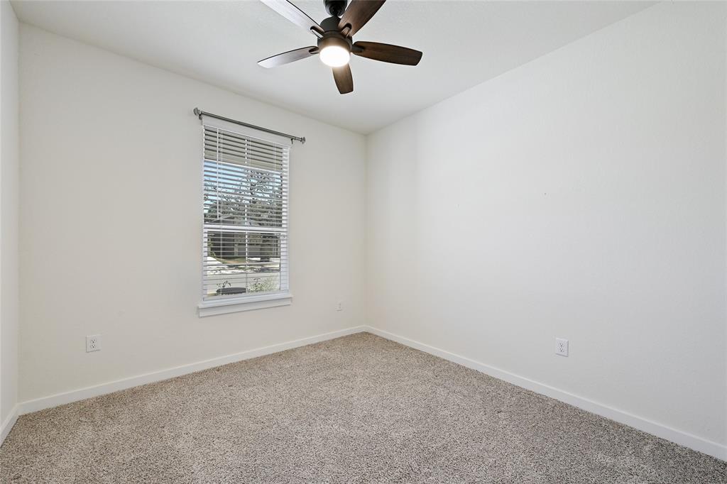 2133 Alamar Walk Leander, TX 78641 - Photo 16 of 25 an empty room with windows and fan