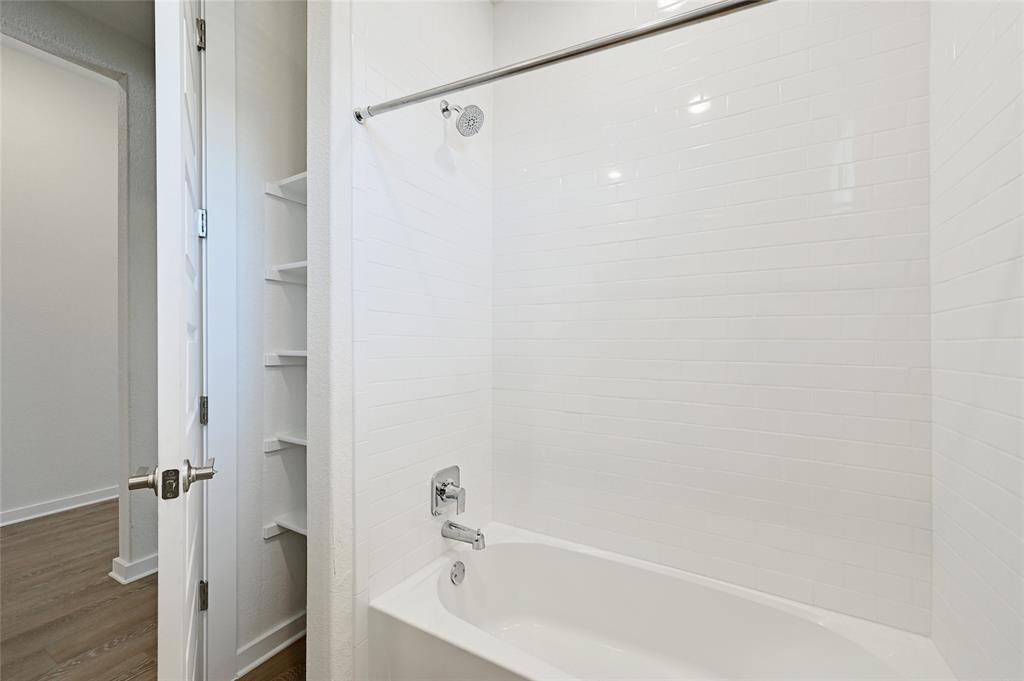 2133 Alamar Walk Leander, TX 78641 - Photo 18 of 25 a bathroom with a bathtub and a shower