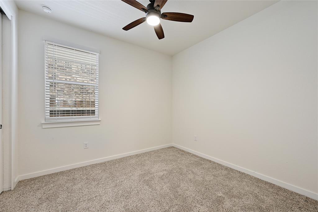 2133 Alamar Walk Leander, TX 78641 - Photo 20 of 25 an empty room with a window and a fan