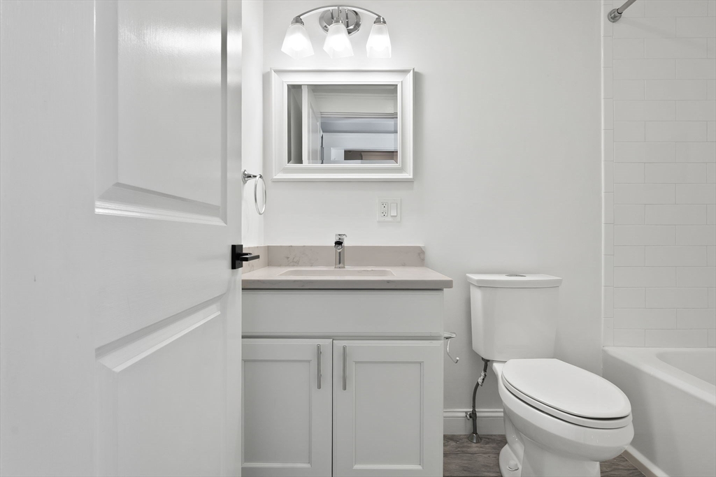85 Bridge Street, Unit 4 Salem, MA 01970 - Photo 14 of 31 a bathroom with a toilet a sink and mirror