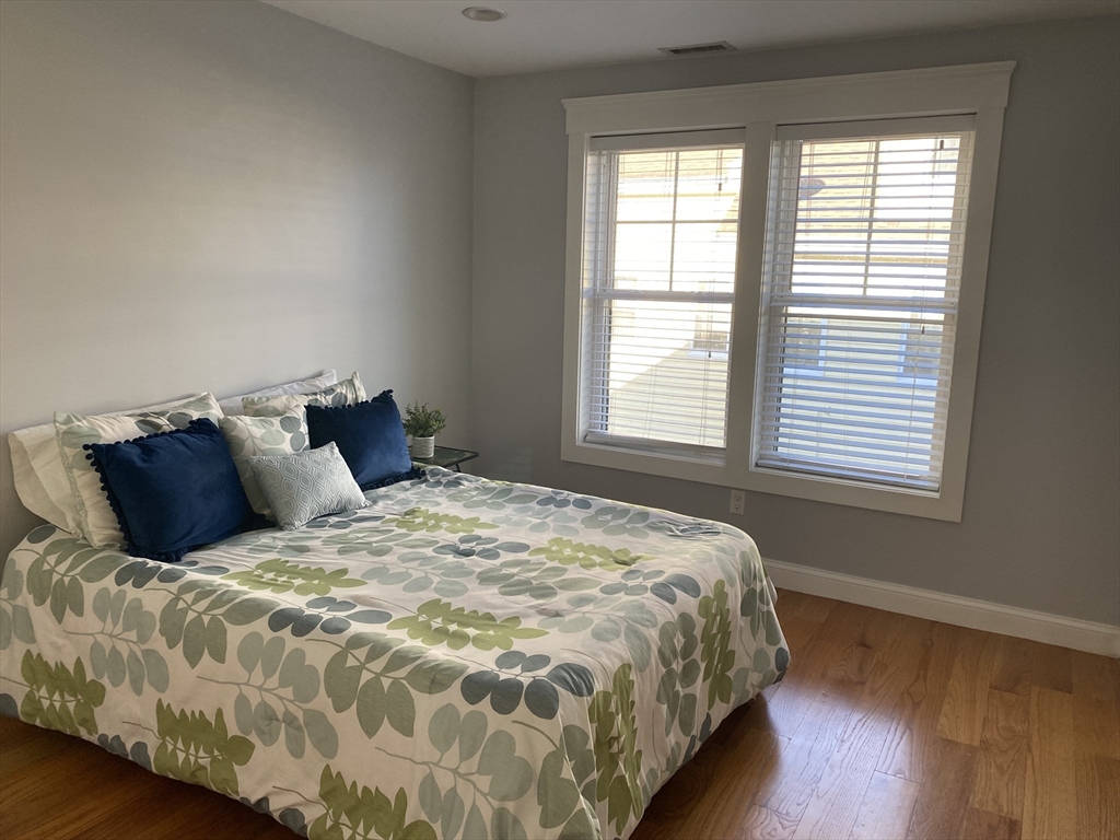 85 Bridge Street, Unit 4 Salem, MA 01970 - Photo 17 of 32 a large bed sitting in a bedroom next to a window