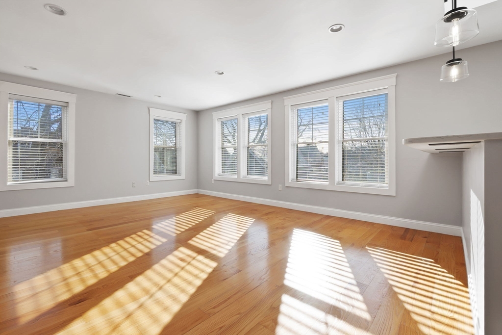 85 Bridge Street, Unit 4 Salem, MA 01970 - Photo 3 of 31 a view of a bedroom with wooden floor and windows