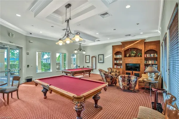 a living room with furniture a rug and a chandelier
