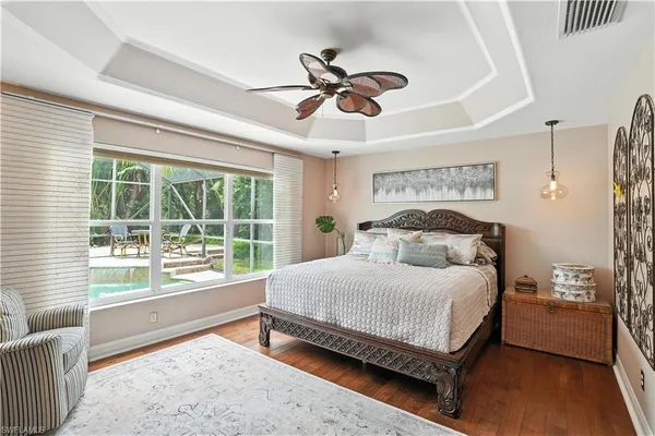 a bedroom with a large bed and a large window