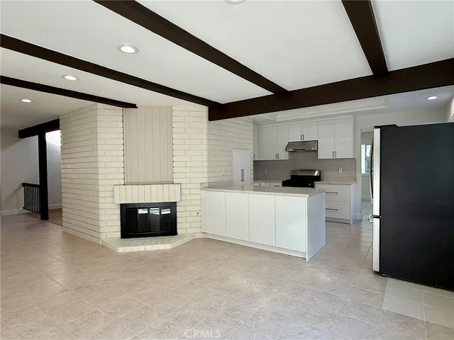 a kitchen with stainless steel appliances kitchen island granite countertop a refrigerator and a stove
