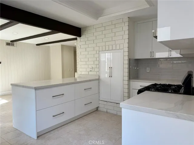 a utility room with cabinets washer and dryer