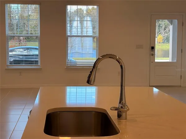 a room with a window and a rug