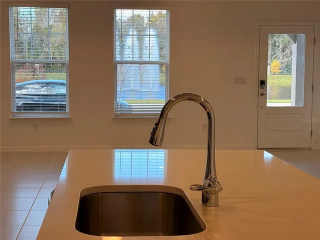 a room with a window and a rug