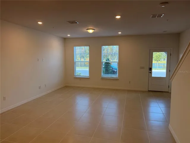 an empty room with windows and closet