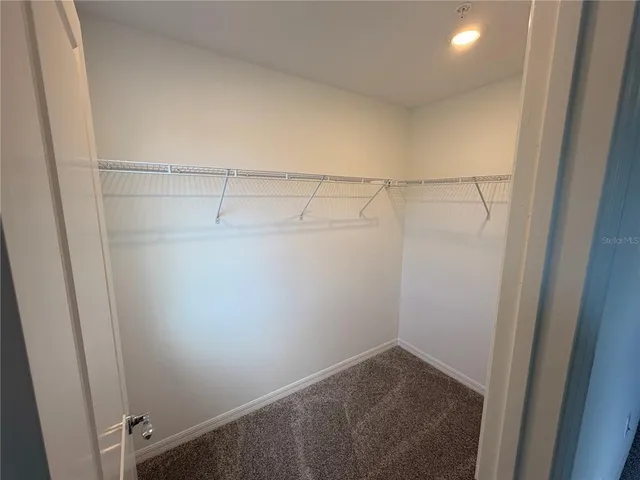 a bathroom with a double vanity sink toilet mirror and shower