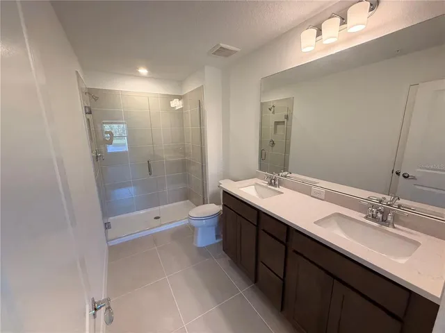 a bathroom with a sink a mirror and a shower