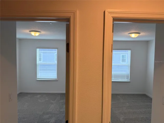 an empty room that has a wooden cupboard
