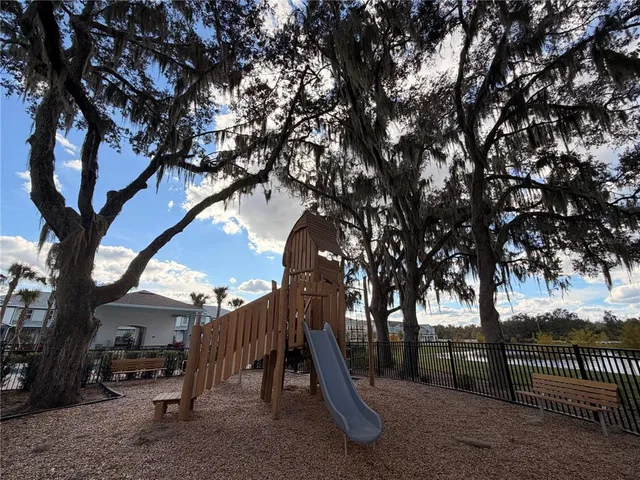 a view of a patio with table and chairs potted plants with wooden fence