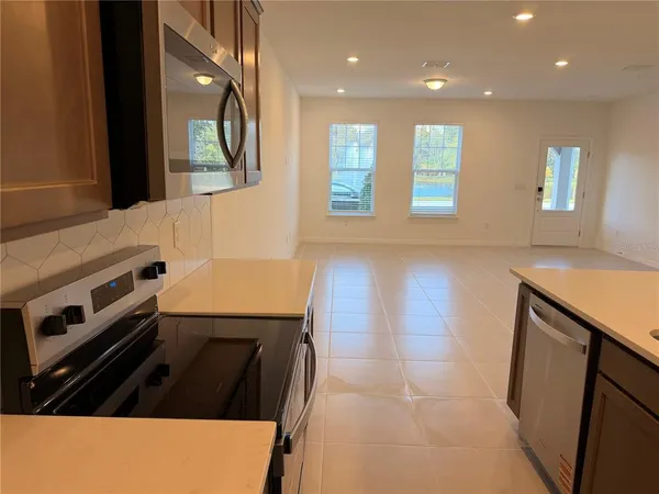 a kitchen with stainless steel appliances granite countertop a stove and a sink