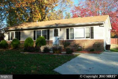 726 Farmington Road West Accokeek, MD 20607 - Photo 1 of 1 a front view of a house with a garden and plants