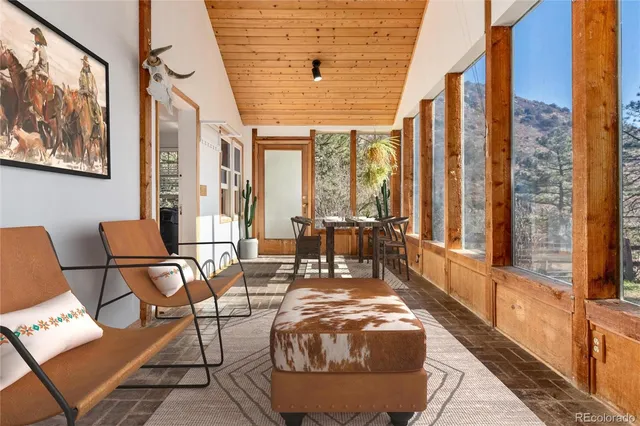 a living room with furniture and a floor to ceiling window