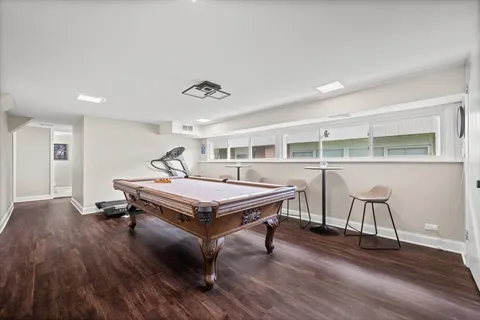 a living room with furniture a table and wooden floor