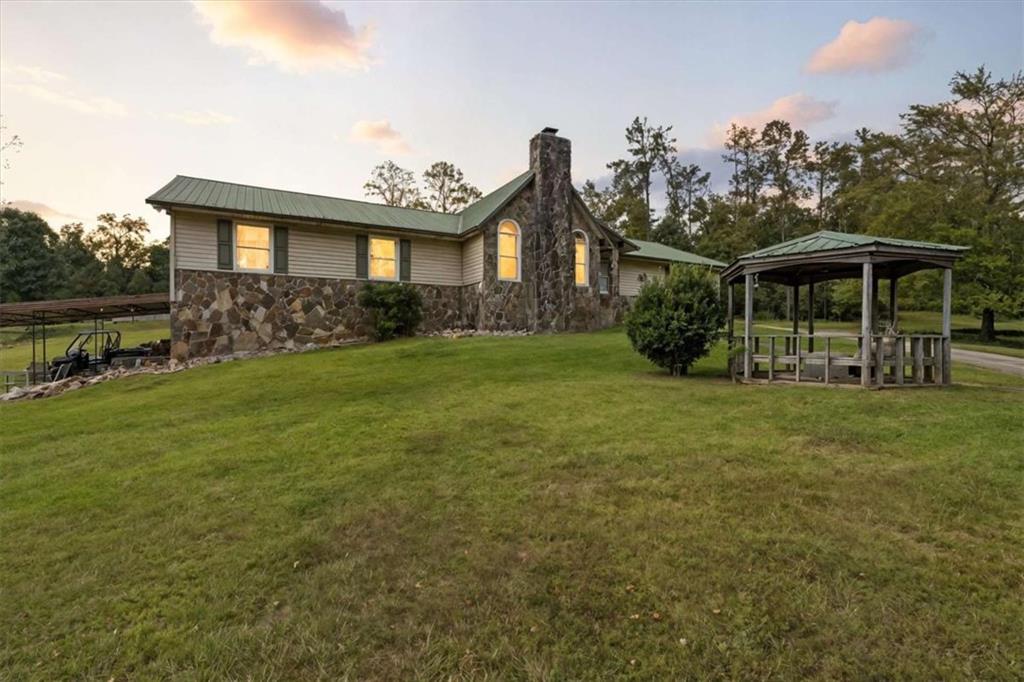 6058 Mt Zion Road Waco, GA 30182 - Photo 11 of 72 a front view of a house with garden