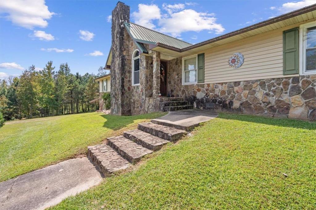 6058 Mt Zion Road Waco, GA 30182 - Photo 12 of 72 a front view of a house with garden