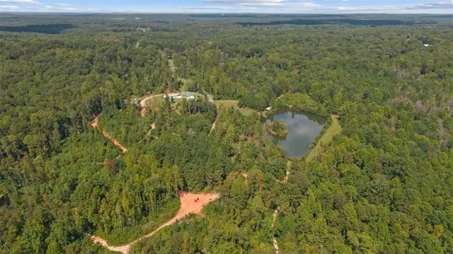 a dining room with furniture and large windows