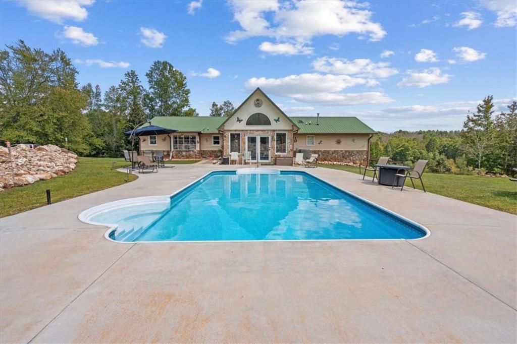6058 Mt Zion Road Waco, GA 30182 - Photo 19 of 72 a view of a house with swimming pool and trees in the background