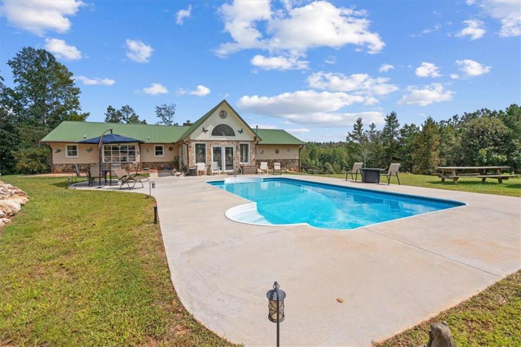 6058 Mt Zion Road Waco, GA 30182 - Photo 20 of 72 a view of a house with swimming pool and sitting area