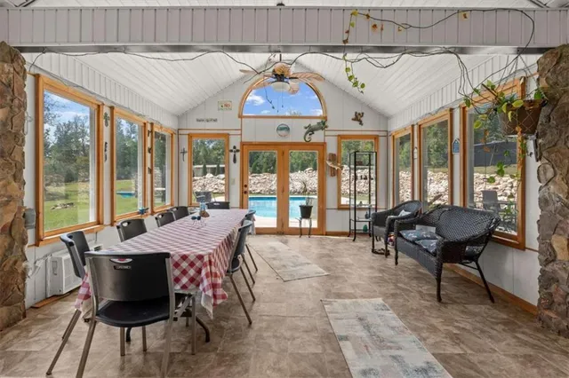 a living room with furniture a clock and a fireplace