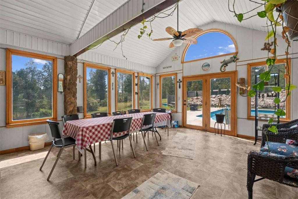6058 Mt Zion Road Waco, GA 30182 - Photo 23 of 72 a dining room with furniture large windows and a chandelier