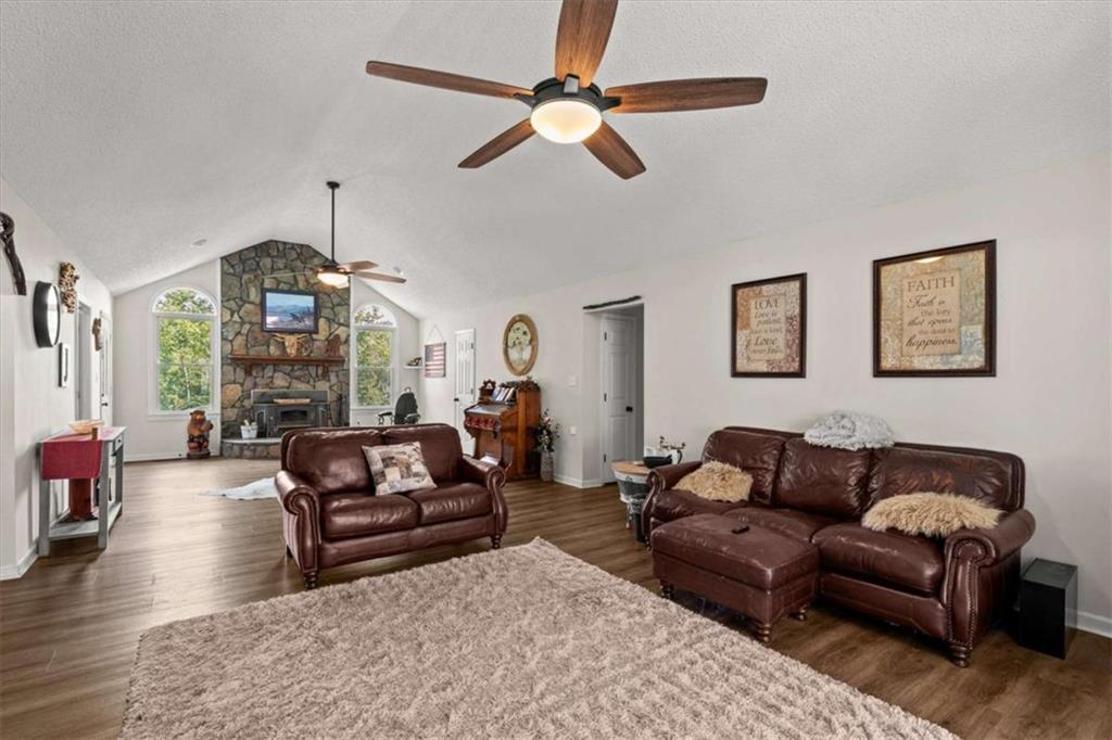 6058 Mt Zion Road Waco, GA 30182 - Photo 26 of 72 a living room with furniture a fireplace and a chandelier