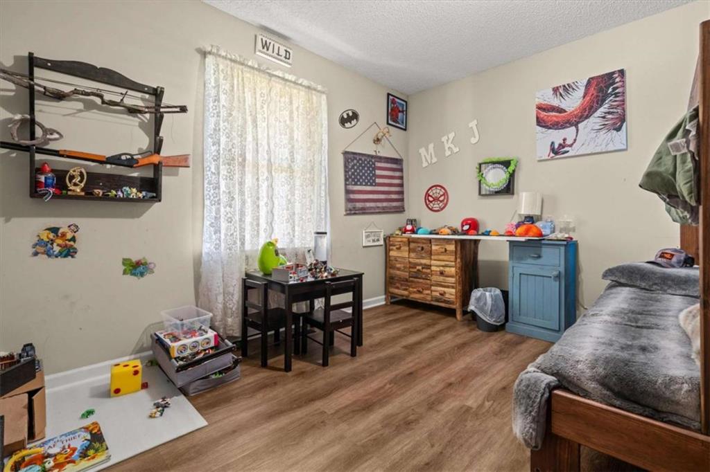6058 Mt Zion Road Waco, GA 30182 - Photo 46 of 72 a living room with furniture and a wooden floor