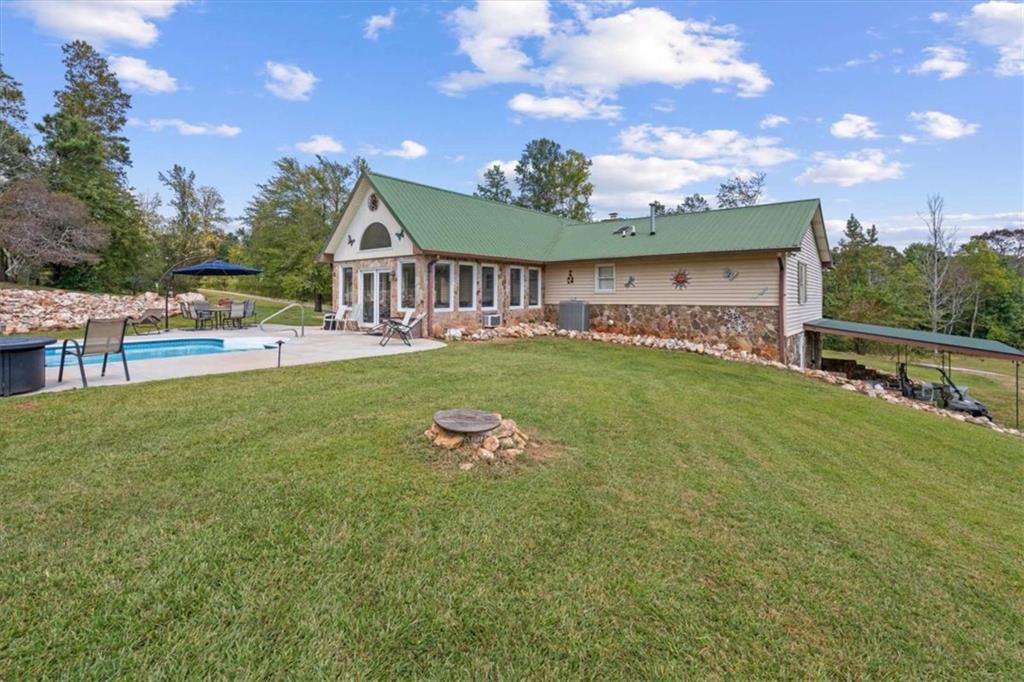 6058 Mt Zion Road Waco, GA 30182 - Photo 53 of 72 a view of a house with a big yard and a large tree